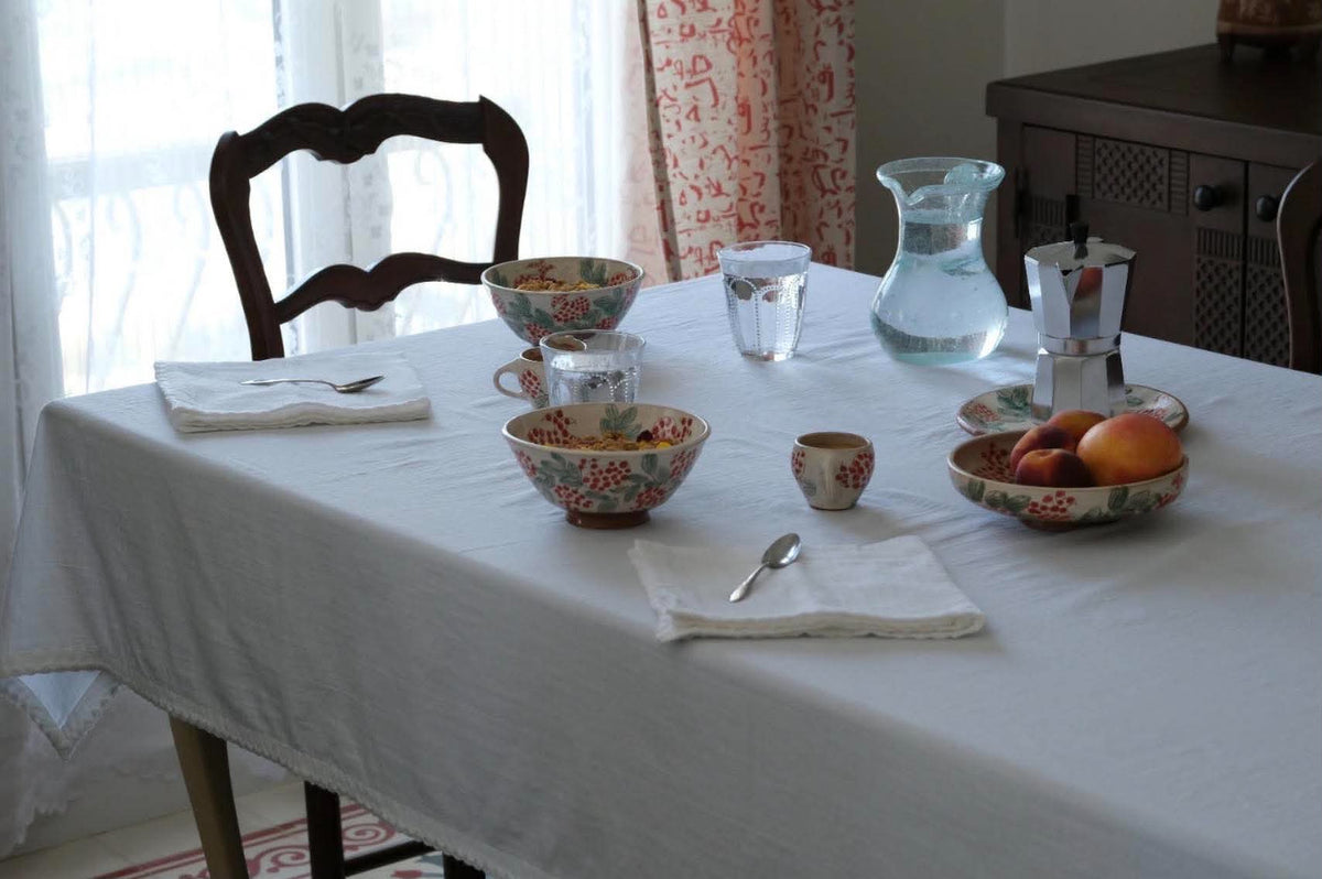 White Egyptian cotton tablecloth on a breakfast table